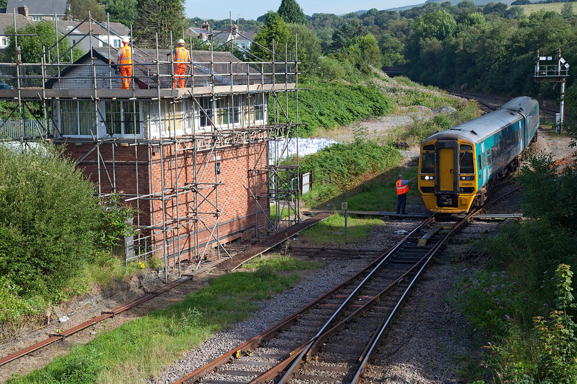 158831, AW 09.16 Maesteg-Cheltenham (2G56), Tondu Junction 
 Tondu Junction is a shadow of its former self with just a single running line now compared with the many that there once were. The GWR Type 3 box that dates from 1884 is being passed by 158831 working the ATW 09.16 Maesteg to Cheltenham Spa service. Note the driver and signalmen exchanging the tablet. 
 Keywords: 158831, AW 09.16 Maesteg-Cheltenham (2G56), Tondu Junction