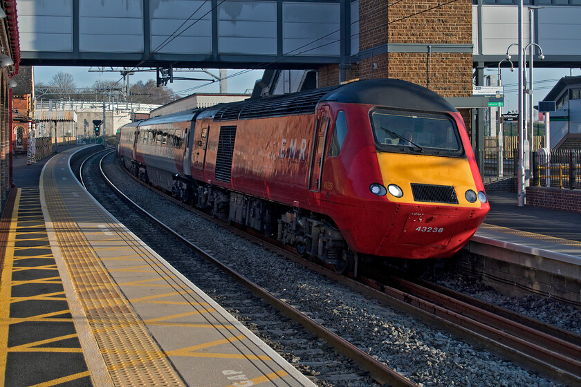 43238, EM 05.19 Leeds-London St. Pancras (1C15, RT), Wellingborough station 
 In their final few weeks of operation, the former ECML HSTs still wearing their Virgin East Coast paint scheme look a little odd on the MML. Their use was always going to be somewhat transient so repainting was probably thought to be an unnecessary extravagance. 43238 leads the 05.19 Leeds to St. Pancras service into Wellingborough station taken, unfortunately, the wrong side for the superb spring sunshine! 
 Keywords: 43238 05.19 Leeds-London St. Pancras 1C15 Wellingborough station EMR HST East Midlands Railway