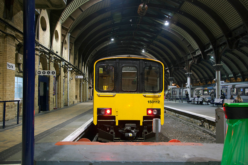 150112, stabled, York station 
 Up until the track was extensively remodelled at York at the same time that it was wired in the late 1980s, there were two north facing bay platforms here. One was removed leaving platform eight as the sole remaining north facing bay that was also electrified. I wonder if, as pressure continues to rise with increased numbers of trains and passengers, the old bay platform to the right will be re-instated? 150112 rests stabled, probably over night, ready for its first working next morning. 
 Keywords: 150112 York station