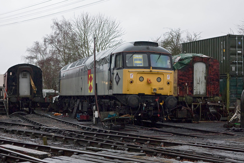 47395, stabled, Pitsford & Brampton Station Yard 
 Resident diesel 47395 stands in the rain partially covered with a tarpaulin in the yard at Pitsford and Brampton station. 
 Keywords: 47395 Pitsford & Brampton Station Yard Northampton and Lamport Railway