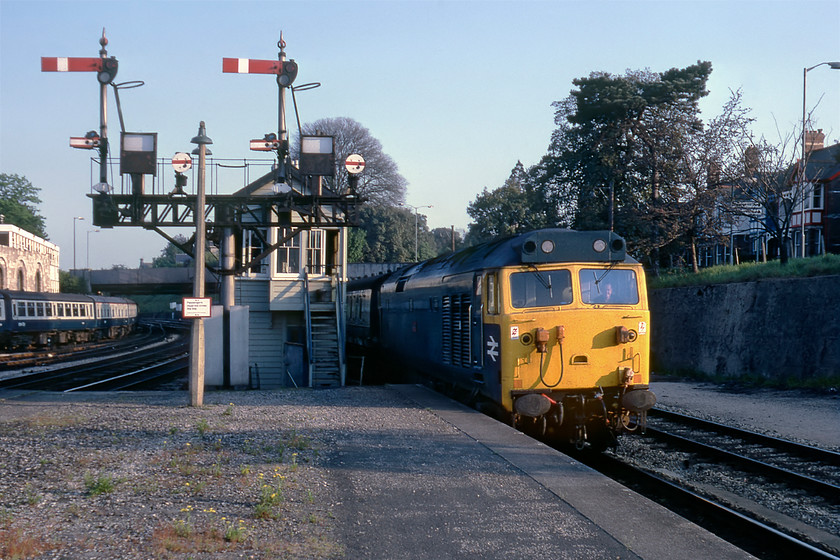 50027, 16.23 Penzance-London Paddington, Newton Abbot station 
 Even back in the pre-internet days of 1980, it was still possible to get gen! We would have caught an earlier train to Exeter and then onwards to Westbury but we had information that the 16.23 Penzance to Paddington HST had been substituted by a locomotive-hauled set and gambled on it being a Class 50; our patience paid off! 50027 'Lion' brings the late running train into Newton Abbot station on the up main platform that no longer exists today. This member of the class was one of the last to head north to Doncaster for its much-needed refurbishment in February 1983. Standing in this position today I would see no superb semaphore signals or signal box but plenty of cars as I would be in the station car park! 
 Keywords: 50027 Lion 16.23 Penzance-London Paddington Newton Abbot station