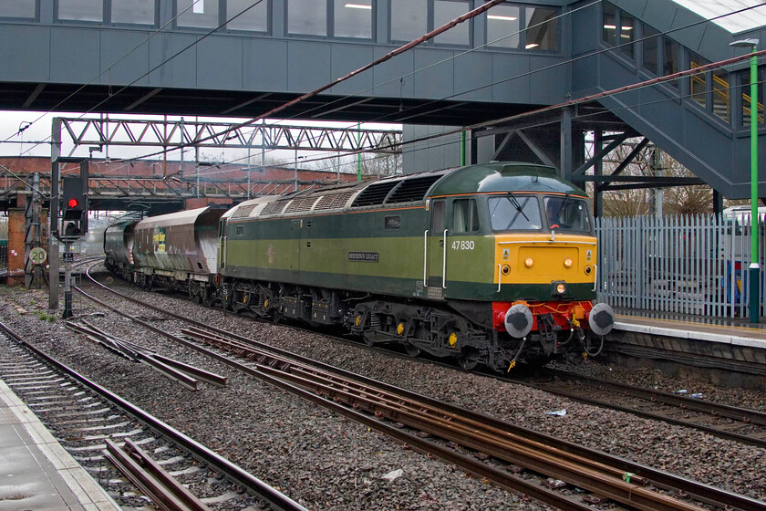 47830, 11.01 Wolverton Centre Sidings-Crewe Basford Hall (4G97, 25E), Northampton station 
 Just as the tail of the previous train, the 4Z43 07.44 Chaddesden Sidings-Wembley Reception Sidings led by veteran 56301, disappeared from view the 4G97 appeared led by an even older locomotive! 47830 (formally 47061 and 47649) 'Beeching's Legacy' leads the 11.01 Wolverton Works (Centre Sidings) to Crewe Basford Hall. This short train was conveying a short rake of former MGR hoppers that are used for barrier work when towing various units. The contrast between the smart appearance of the Class 47 and the graffiti-ridden state of the wagons is extremely marked! Approaching its sixtieth year in operation 47830 trumps the previously seen 56301 at forty-five years but with a combined age of over one hundred years does it dispel the notion that we have a modern railway? 
 Keywords: 47830 11.01 Wolverton Centre Sidings-Crewe Basford Hall 4G97 Northampton station Brush Duff Beeching's Legacy