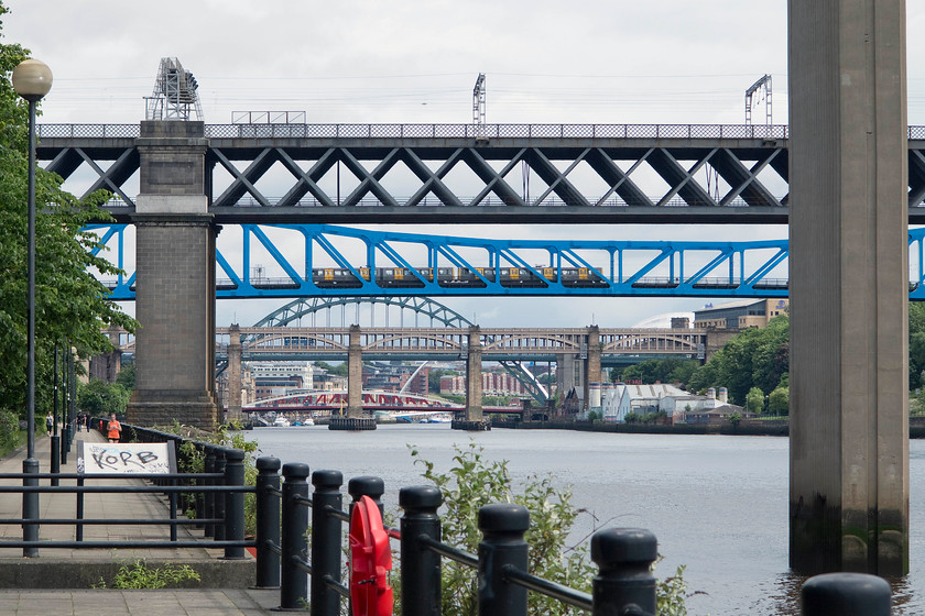 Class 994, TW 11.37 South Hylton-Newcastle Airport, crossing Metro bridge, Newcastle 
 Looking down the River Tyne reveals a number of its classic and familiar bridges. Crossing the Tyne Bridge is a Metro class 994 working the 11.37 South Hylton to Newcastle Airport service. I think this is a fascinating picture that reminds us of a time when our industrial heritage really did rule! 
 Keywords: Class 994 11.37 South Hylton-Newcastle Airport crossing Metro bridge Newcastle