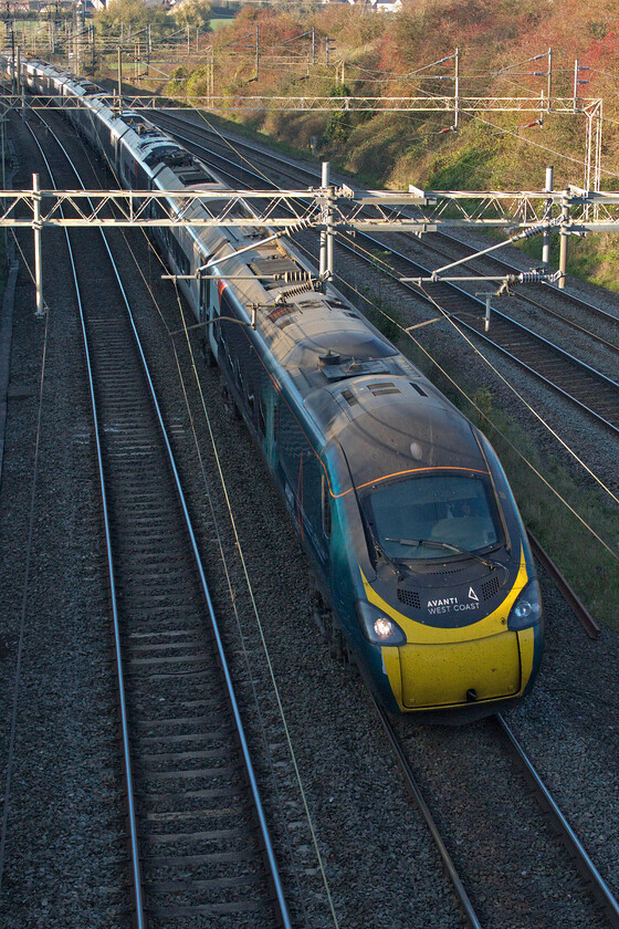 390122, VT 09.30 Glasgow Central-London Euston (1Z10, 11E), Victoria bridge 
 390122 'Penny the Pendolino' sweeps around a curve just south of Roade in Northamptonshire working the 09.30 Glasgow Central to London Euston Avanti service. With Avanti West Coast still in difficulties and working under a notice to improve they have re-cast their timetable that also includes many of their train reporting numbers. In this particular case, this one was operating as 1Z10 one that a charter would ordinarily use with Z being used for charters, railtours, emergency trains or as-required locomotive moves. 
 Keywords: 390122 09.30 Glasgow Central-London Euston 1Z10 Victoria bridge AWC Avanti Pendolino Penny the Pendolino