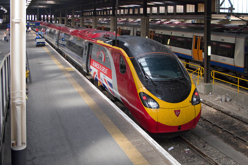 390151, VT 14.03 London Euston-Birmingham New Street (9G25), London Euston station 
 Taken from one of the access ramps at Euston station instantly recognisable 390151 with its 'Business is Great' vinyls attached to the power car. The Virgin Pendolino is about to work the 14.03 to Birmingham New Street. 
 Keywords: 390151 14.03 London Euston-Birmingham New Street 9G25 London Euston station Virgin Trains West Coast Pendolino