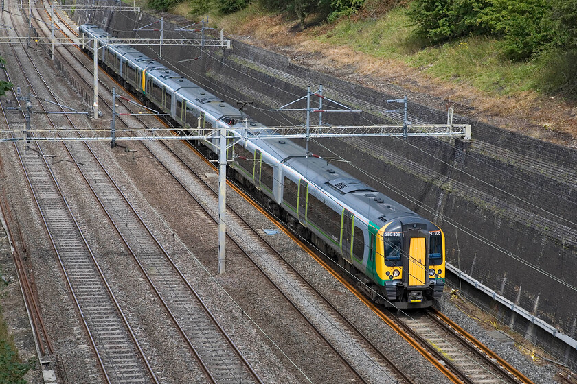 350108, LM 11.14 Birmingham New Street-London Euston, Roade cutting 
 London Midland's 350108 leads another unit through Roade cutting working the 11.14 Birmingham New Street to Euston service. 
 Keywords: 350108 11.14 Birmingham New Street-London Euston, Roade cutting London Midland Desiro