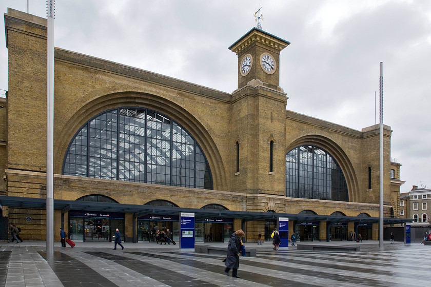 Frontage, London King's Cross station 
 The Cubitt brothers (Lewis, Thomas and William) were all involved in various aspect of civil engineering with William going on to be the Lord Mayor of London for two concurrent terms from 1860 to 1862. The superb brick frontage of King's Cross was designed by the youngest of the bothers, Lewis, who did a lot of work for the Great Northern Railway under its resident engineer George Turnbill. The station opened in October 1852 but over the years it became a little lost as it became surrounded by more modern developments. Indeed, under BR in the early 1970s a large single story extension was added with most of the now paved area in the foreground covered. Whilst the thirty five-metre tall clock tower remained the whole area was a bit of an architectural mess. The recent and massive redevelopment of the station has once again revealed the grandeur of the frontage in its full glory; let's hope that it stays this way for many years to come 
 Keywords: Frontage London King's Cross station