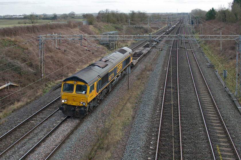 66715, 11.39 London Gateway-Hans Hall (4M47, 3L), Victoria bridge 
 Having what must rank as one of the longest names on a locomotive 66715 'Valour. In Memory of all Railway Employees Who Gave Their Lives For Their Country' leads the completely boxless 4M47 11.39 London Gateway to Hams Hall past Victoria bridge between Roade and Ashton. I wonder if ships held up and diverted via the Cape due the awful conflict in the Middle East has led to a lack if freight? The Class 66 has worn its plates for fourteen years since naming as part of the Remembrance commemorations in November 2010. 
 Keywords: 66715 11.39 London Gateway-Hans Hall 4M47 Victoria bridge GBRf Valour. In Memory of all Railway Employees Who Gave Their Lives For Their Country