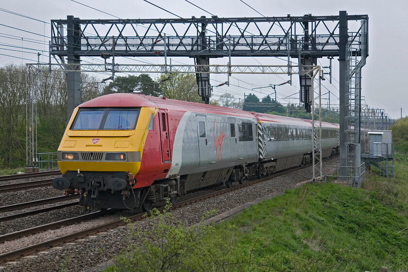 82126, LM 07.44 Northampton-London Euston (1T15), Roade Hill 
 Now then, this is the way for football supporters to get to a match! London Midland have hired in Virgin's Pretendolino set to add capacity to get football supporters from Northampton to Wembley. Still Virgin branded, 82126 leads the set of stock past Roade with supporters looking forward to their League 2 play-off match with Bradford City. 
 Keywords: 82126 07.44 Northampton-London Euston 1T15 Roade Hill Virgin Pretendelino