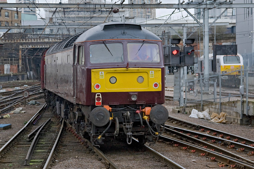 47746, outward leg of The Cathedrals Express, 09.11 London King's Cross-Shildon (1Z24) & 67026, stabled thunderbird, King's Cross station 
 Having brought the empty coaching stock in from Hornsey a little earlier 47746 now has an easy time of it being dragged all the way to County Durham! With a driver sitting in the rear-facing cab it leaves King's Cross at the rear of the 1Z24 09.11 to Shildon, The Cathedrals Express with 47580 'County of Essex' leading at the front. Station thunderbird 67026 is seen to the right stabled in front of King's Cross' power box. 
 Keywords: 47746 The Cathedrals Express 09.11 London King's Cross-Shildon 1Z24 67026, stabled thunderbird King's Cross station