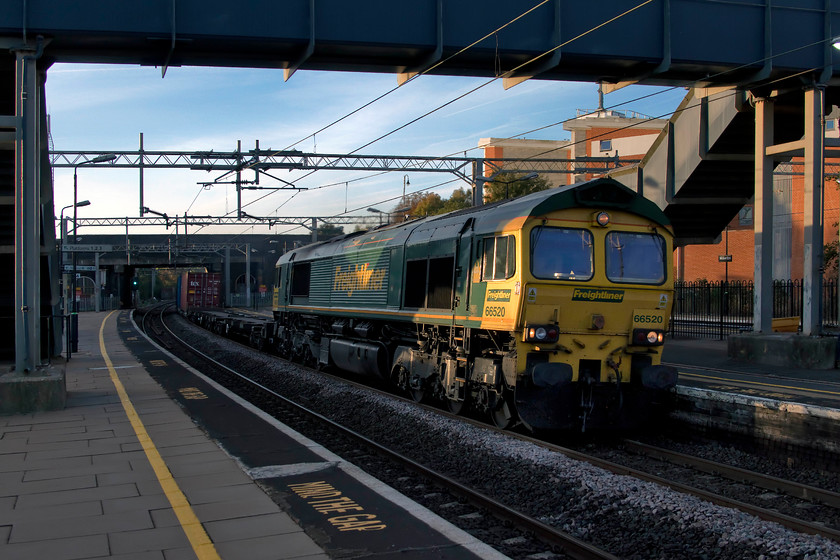 66520, 02.57 Felixstowe North-Garston (4M45), Wolverton station 
 66520 just catches some early morning sun as it speeds through Wolverton station leading the 02.57 Felixstowe to Garston 4M45 Freightliner. This picture is not perfectly positioned as the nice lady was warning customers to 'stand well back from the edge of platform three' as I was walking through the station car park so it was a bit of a 'sprint and grab' shot! 
 Keywords: 66520 02.57 Felixstowe North-Garston 4M45 Wolverton station