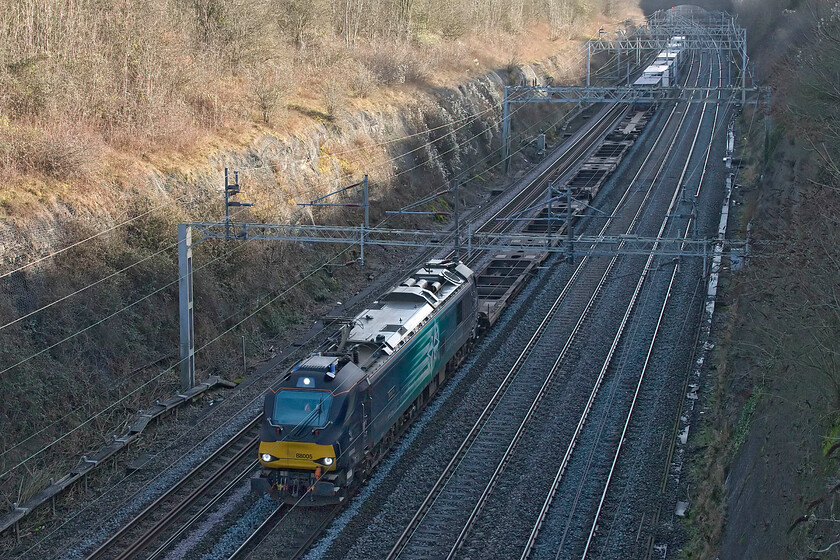 88005, 08.45 Tilbury-Coatbridge (4S10, 23L), Roade cutting 
 88005 'Minerva' leads the 4A10 08.45 Tilbury to Coatbridge service through the wintery depths of Roade cutting. Whilst it is not good photographic practice to take photographs in deep shadow on a sunny day with such a grand location as Roade cutting available the rules have to be broken and Photoshop employed to put things right! 
 Keywords: 88005 08.45 Tilbury-Coatbridge 4S10 Roade cutting Minerva