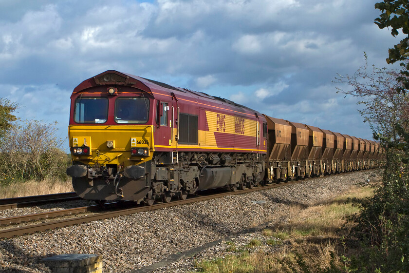 66035, 10.35 Acton-Moreton-on-Lugg (6B35), South Marston foot crossing SU193869 
 Taken from the security of a foot crossing at South Marston just east of Swindon a smart-looking 66035 heads an empty ballast train. The 6B35 10.35 Acton to Moreton-on-Lugg service will travel westwards via the GWML to South Wales before then heading northwards along the Marches line at Maindee Junction. At Moreton-on-Lugg the wagons will be filled with gravel extracted from Tarmac's quarry that looks as though it is going to be expanded if the plans go through. 
 Keywords: 66035 10.35 Acton-Moreton-on-Lugg 6B35 South Marston foot crossing SU193869