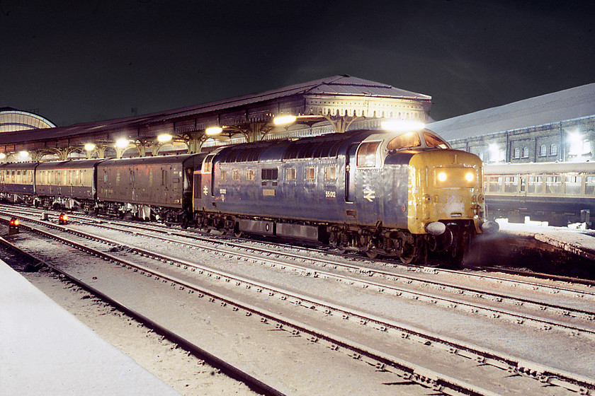 55012, 20.45 Edinburgh-London King's Cross sleeper (sleepers from Newcastle) (1E35), York station 
 With the stock encrusted with snow 55012 Crepello has brought the 1E35 20.45 Edinburgh-London King's Cross sleeper into York. During the winter months, this working only had two sleeper coaches that were attached at Newcastle. Notice the whisp of steam escaping from the pipework on the front of the locomotive. 
 Keywords: 55012 20.45 Edinburgh-London King's Cross sleeper sleepers from Newcastle 1E35 York station Deltic Crepello