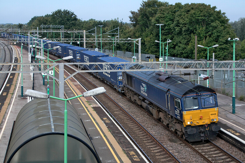 66429, 10.38 DIRFT-Tilbury (4L48, 2L), Wolverton station 
 Running a little late after a lengthy and complicated diversion away from the Northampton line due to engineering works the Sunday 4L48 DIRFT to Tilbury 'Tesco Express' passes Wolverton at speed! Regular DRS performer 66429 is leading the train that crossed from the fast to the slow line a short distance north of this location at Hanslope Junction. 
 Keywords: 66429 10.38 DIRFT-Tilbury 4L48 Wolverton station Daventry Intercity Railfreight terminal