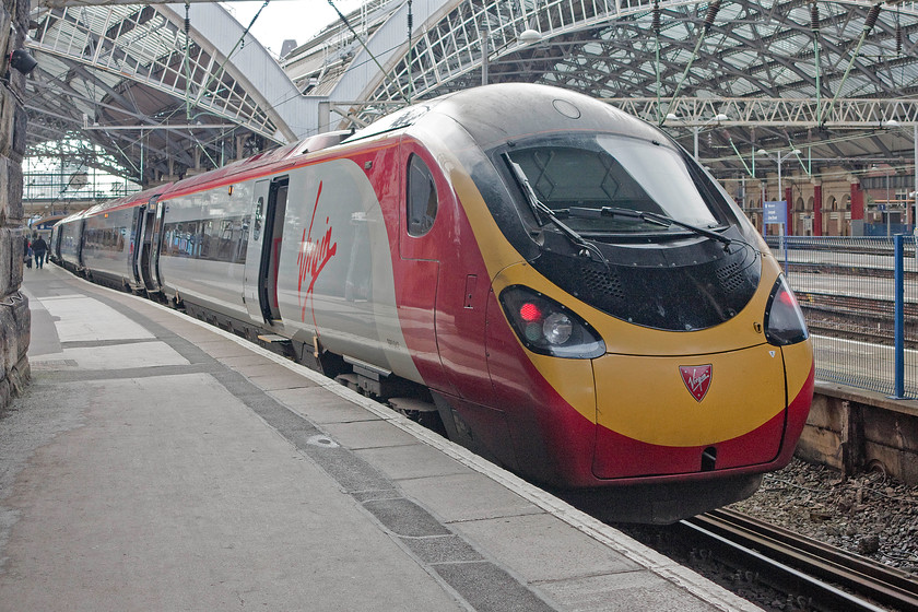 390042, VT 15.07 London Euston-Liverpool Lime Street (1F19), Liverpool Lime Street station 
 The tail end of 390042 'City of Bangor/Dinas Bangor' at Lime street station having just arrived with the 1F19 15.07 from London Euston. In the background, the platforms of Lime Street look surprisingly quiet given it is just about peak hour time. 
 Keywords: 390042 15.07 London Euston-Liverpool Lime Street 1F19 Liverpool Lime Street station