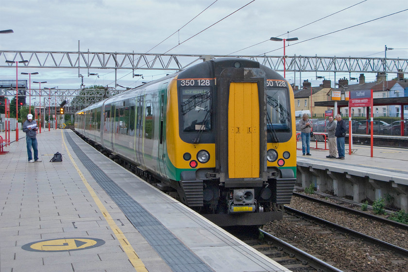 350128, LM 06.24 London Euston-Crewe (2U23), Stafford station 
 There is generally a number of spotters found on Stafford station and this morning is no exception. However, none of the four seen in this view is taking any notice of London Midland's 350128 as it leaves the station working the 06.24 Euston to Crewe. My boss and I had taken this train from Northampton as the first train of our journey to Bradford. 
 Keywords: 350128 06.24 London Euston-Crewe 2U23 Stafford station London Midland Desiro