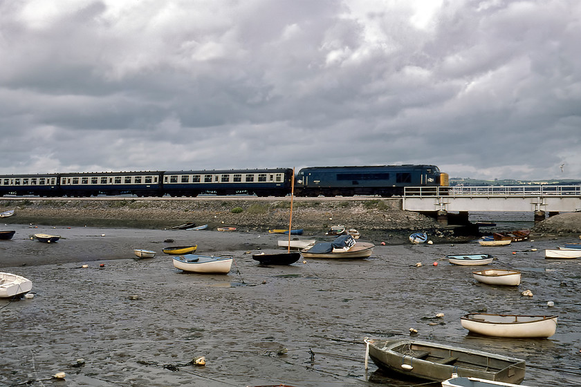 46044, 09.08 Newcastle-Paignton (1V87), Cockwood Harbour 
 A regular route that the Class 46s could be found on was the NE (Newcastle) to SW (Paignton, Plymouth and Penzance) with both Gateshead and Plymouth having an allocation of the class for such services. Indeed, 46044 seen here was a Gateshead locomotive from May 1973 until it was condemned in April 1984. It is seen passing Cockwood harbour between Starcross and Dawlish Warren leading the 1V87 09.08 Newcastle to Paignton train. Unfortunately, since the previous photograph was taken the sun has gone in behind some heavy cloud that has completely changed the quality of the image. 
 Keywords: 46044 09.08 Newcastle-Paignton 1V87 Cockwood Harbour Peak