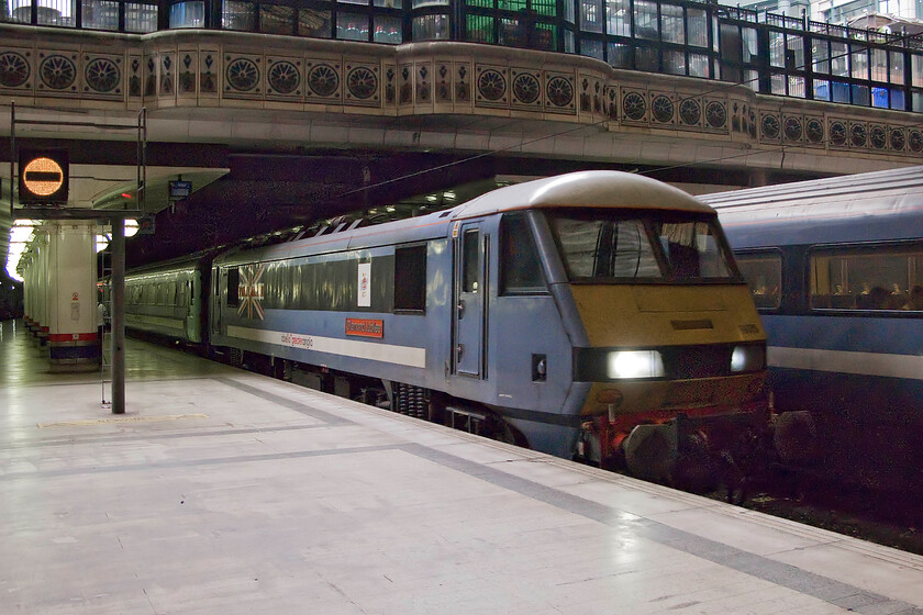 90009, LE 09.00 Norwich-London Liverpool Street (1P23), London Liverpool station 
 Taken inside the gloom of Liverpool Street station 90009 'Diamond Jubilee' arrives with the 1P23 09.00 Abellio Greater Anglia service from Norwich. Myself and a small number of enthusiasts were making our way to the far end of the station to capture the arrival of a Hastings Diesels charter but we were accompanied by platform security staff twitchy at our presence. 
 Keywords: 90009 09.00 Norwich-London Liverpool Street 1P23 London Liverpool station Diamond Jubilee Abellio Greater Anglia