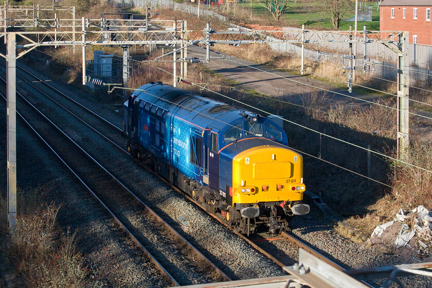 37611, 11.48 Derby RTC-Wembley Yard (0H72, 5E), site of Roade station

Yet another Rail Operations Group light engine move involving one of their ever-dependable Class 37s passes Roade catching a short gap between the deep winter shadows. This time, 37611 'Denise' runs south as the 0H72 11.48 Derby RTC to Wembley Yard. It transpired that the Class 37 was to be used on a drag of a Capitalstar (Class 378) in a couple of days. 
 Keywords: 37611 11.48 Derby RTC-Wembley Yard 0H72 site of Roade station ROG Rail Operations Group Denise