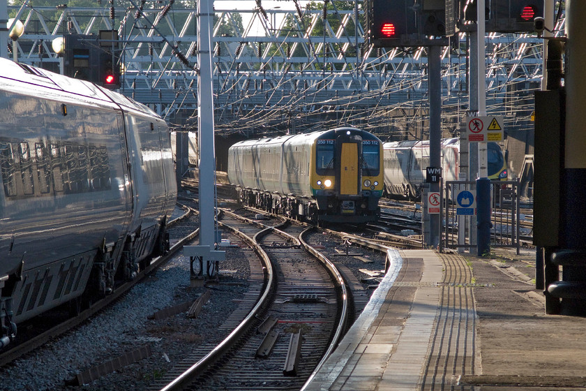 350112, LM 17.33 Birmingham New Street-London Euston (1W24), London Euston station 
 A busy scene at the country end of Euston station. A Virgin Pendolino arrives to the left whilst anther leaves to the right. Meanwhile, 350112 arrives working London Midland's 17.33 from Birmingham New Street. 
 Keywords: 350112 17.33 Birmingham New Street-London Euston 1W24 London Euston station London Midland Desiro