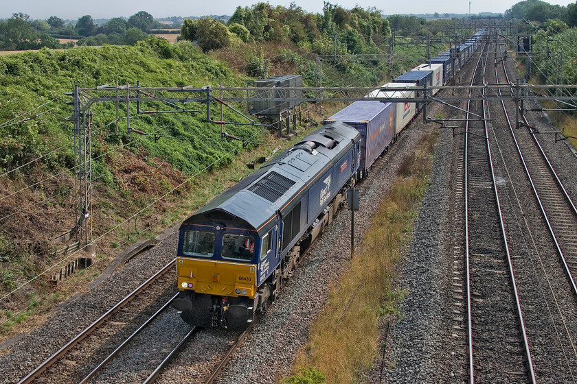 66433, 10.28 Tilbury-DIRFT (4M07, 4E), Victoria bridge 
 Just a few minutes after the up Tesco Express headed south the northbound working passed led by 66433 'Carlisle Power Signal Box-50th Anniversary 1973-2023'. Named in June 2023 in a short ceremony at Carlise station the smart DRS Class 66 is leading the 4M0 10.28 Tilbury to DIRFT service just a few miles from its destination here at Victoria bridge near Roade. 
 Keywords: 66433 10.28 Tilbury-DIRFT 4M07 Victoria bridge Carlisle Power Signal Box - 50th Anniversary 1973-2023.