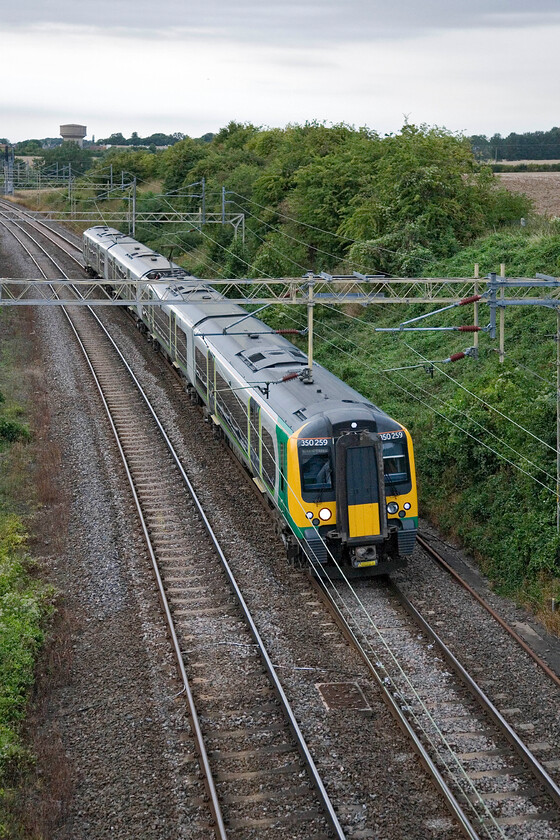 350259, LM 17.33 Birmingham New Street-London Euston, Victoria bridge 
 Approaching the end of August means that by 19.00 (when this image was captured) the light is beginning to fade fairly fast. Under grey skies, 350259 heads south with the village of Roade in the background working the 17.33 Birmingham New Street to Euston service. 
 Keywords: 350259 17.33 Birmingham New Street-London Euston Victoria bridge London Midland Desiro