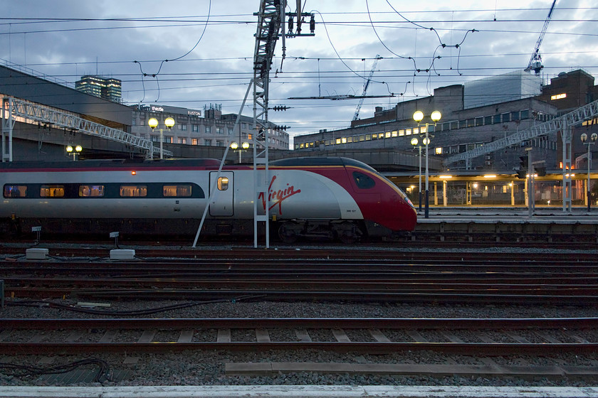 390127, VT 19.43 London Euston-Crewe (9K42, RT), London Euston station 
 390127 'Virgin Buccaneer' sits in the half light at Euston about to leave with the 9K42 19.43 to Crewe. I love the lighting in this picture, but it's a shame that the driver could not position the Pendolino better with the Virgin logo in full view! 
 Keywords: 390127 19.43 London Euston-Crewe 9K42 London Euston station