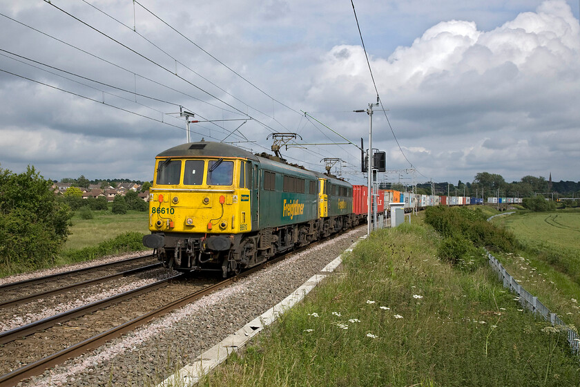 1. 86610 & 86617, 11.13 Felixstowe North-Trafford Park (4M87), Wilson's crossing 
 The 4L87 afternoon Freightliner accelerates away from Northampton past Wilson's crossing with 86601 and 86617 leading the train. It is noticeable how much faster the vintage AL6s go on this rising gradient when compared to a Class 66 hauling an equivalent train. Unfortunately with a double-headed train, it is not quite possible from this angle to capture both locomotives between the two electrification masts. 
 Keywords: 86610 86617 11.13 Felixstowe North-Trafford Park 4M87 Wilson's crossing AL6 Freightliner