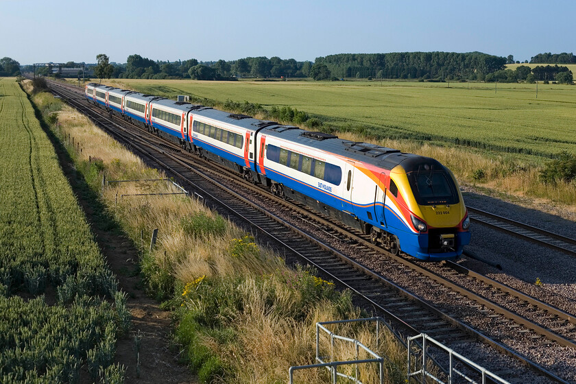 222004, EM 17.27 Sheffield-London St. Pancras, Harrowden Junction 
 With the lengthening shadows from the July evening sun 222004 passes Harrowden Junction working EMT's 17.27 Sheffield to St. Pancras service. The wheat fields on either side of the tracks are doing well but need some more weeks of good solid sunshine to ripen them off to be harvested next month. 
 Keywords: 222004 17.27 Sheffield-London St. Pancras Harrowden Junction EMT East Midlands Trains Meridian