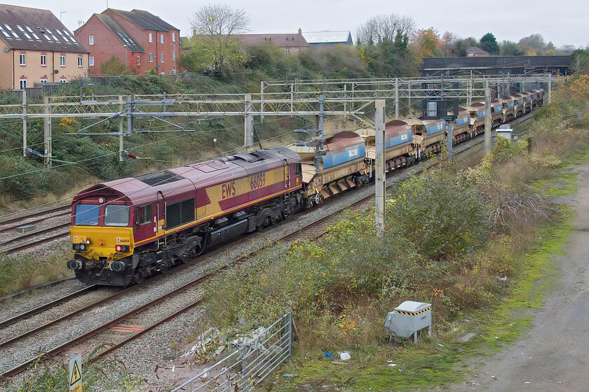 66056 & 66176, 07.00 Bourne End-Bescot Yard (6R01, 3E), site of Roade station 
 Returning from overnight engineering works on the WCML near Bourne End (Hertfordshire) 66056 brings up the rear of the 6R01 07.00 Bourne End to Bescot Yard with 66176 leading at the front. Having had a Sunday morning walk to witness the passing of this train I headed home for breakfast! 
 Keywords: 66056 66176, 07.00 Bourne End-Bescot Yard 6R01 site of Roade station EWS