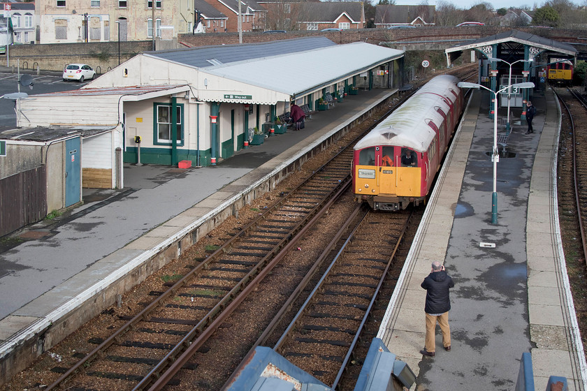 483008, SW 12.07 Ryde Pier Head-Shanklin (2D27), Ryde St. John`s Road station 
 Ryde St. John's Road station was a little rundown with pretty basic facilities despite its size and location. Andy photographs 483008 as it arrives with the 12.07 Ryde to Shanklin service that we took all the way to the end of the line. In the background under the bridge is 483004 out of use but allegedly available for service. 
 Keywords: 483008 12.07 Ryde Pier Head-Shanklin 2D27 Ryde St. John`s Road station Island Line SWT 1938 London Underground stock