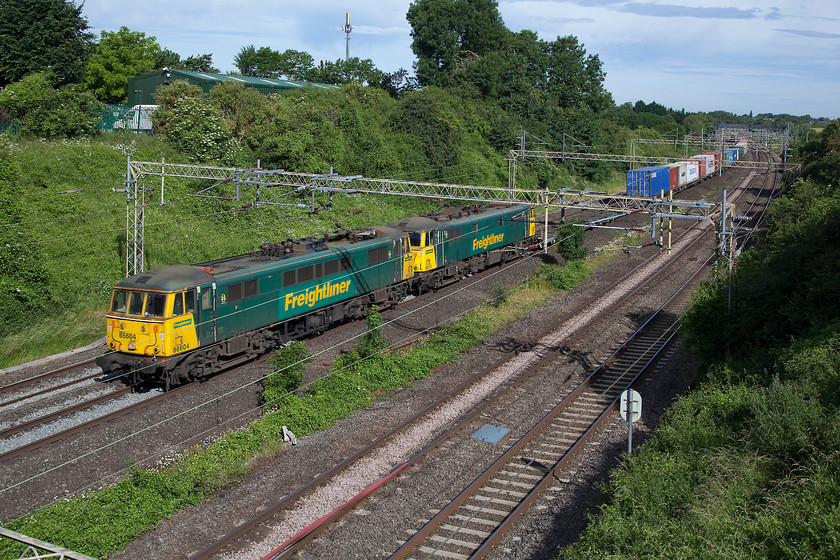 86604 & 86610, 22.09 Coatbridge-Felixstowe North (4L89), on the up fast, Victoria Bridge 
 I suspect that as 86004 and 86010 (later to become 86404 and 86410) these two vintage machines had traversed this line many times during their earlier career when hauling West Coast express passenger trains. The vintage 86s are seen leading the overnight 4L89 22.09 Coatbridge to Felixstowe Freightliner past Victoria Bridge near to Roade in Northamptonshire on the up fast via the Weedon loop. They will have been doing this at considerably less than their previous 110mph maximum speed when they were frontline locomotives on the WCML. They were diverted because of the emergency closure of the Northampton to Rugby line. 
 Keywords: 86604 86610 22.09 Coatbridge-Felixstowe North 4L89 Victoria Bridge