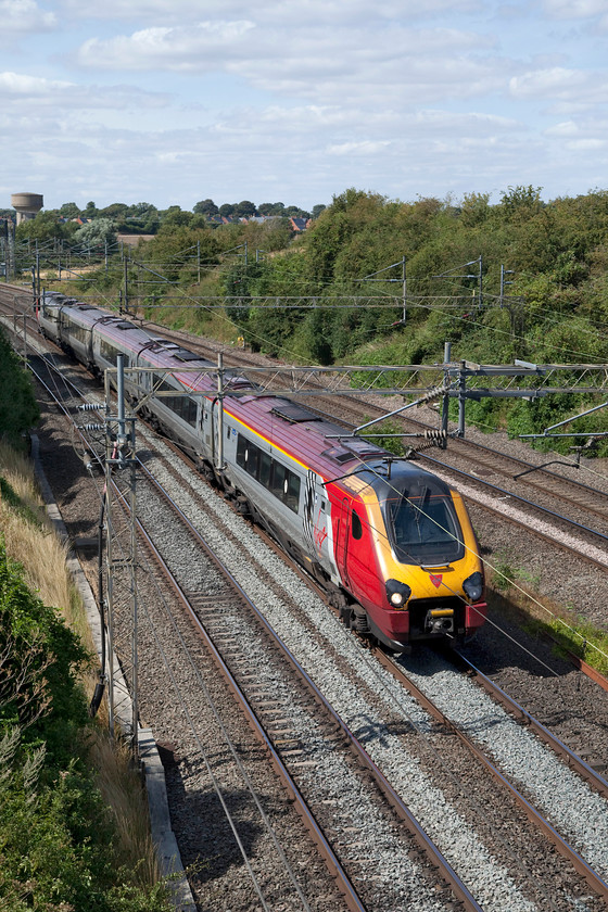 221110, VT 13.35 Chester-London Euston (1A38, 6L), Victoria Bridge 
 With one of Roade's characteristic water-towers in the background that, incidentally, has been sold to be turned into a house, 221110 'James Cook' passes Victoria Bridge. The Voyager was working the 1A38 13.35 Chester to London Euston. 
 Keywords: 221110 1A38 Victoria Bridge