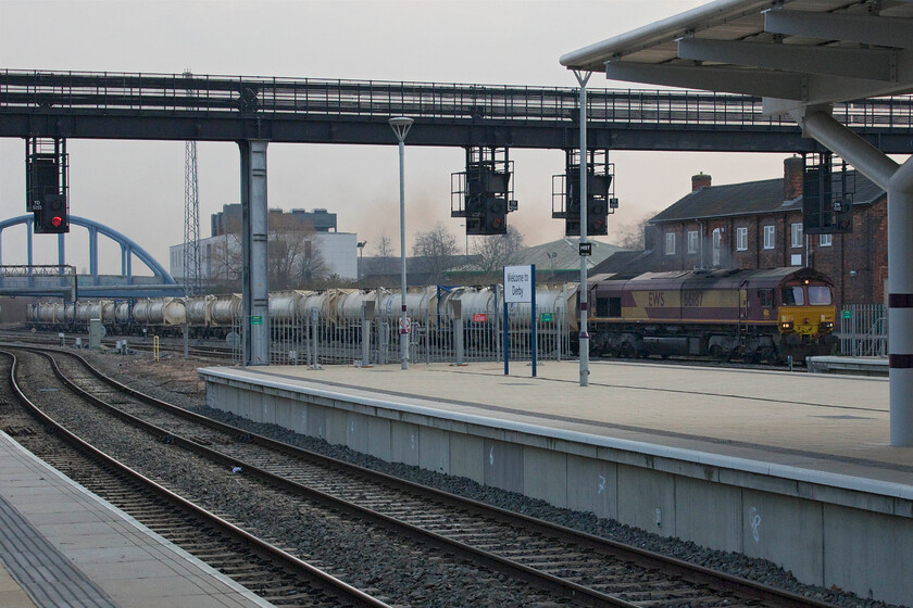 66187, 12.00 Appleford Sidings-Milford West (6E11, 5E), Derby station 
 The 6E11 12.00 Appleford sidings (just south of Oxford) to Milford West is led through Derby station by 66187. This is a total 'grab shot' but one that shows the barren concrete openess of the new Derby station. 
 Keywords: 66187 12.00 Appleford Sidings-Milford West 6E11 Derby station