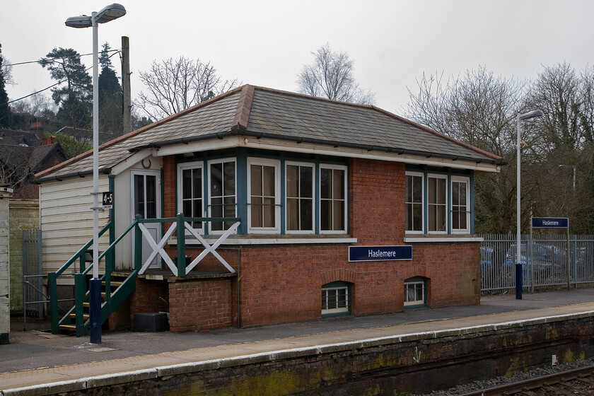 Haslemere signal box (LSW, 1895) 
 As was a common practice for the LSW Railway Haslemere signal box is located on the station platform. It's an attractive and typical design that still houses a forty-seven lever frame that the signalman is busy operating as the line sees regular services. The box is Grade II listed so its future is secure when Network Rail re-signal the line sometime in the not too distant future. 
 Keywords: Haslemere signal box LSW London and South Western Railway