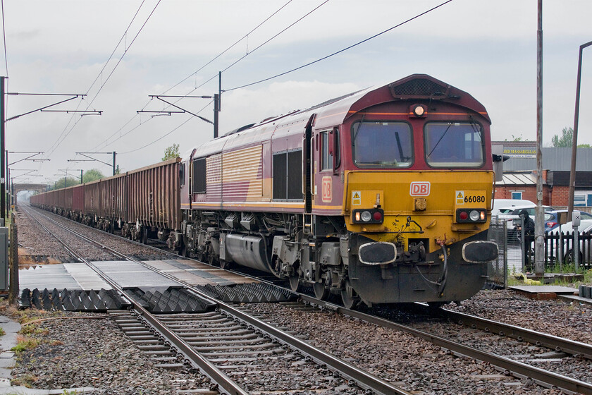 66080, 11.10 Scunthorpe Roxby Gullet-Rossington Loading Point (6D55, 16E), Bentley station 
 Completing its near one hundred and eighty-degree move now heading south-east the 6D55 11.10 Scunthorpe Roxby Gullet to Rossington loading point is seen returning composed of a rake of empty MBA monster box wagons. The return working will be carrying spoil from the site of the former Rossington colliery that is now being redeveloped for a vast new housing development. The train is seen crawling through Bentley station with 66080 at the helm. I was really pleased to capture this locomotive as it represents a photographic cop. 
 Keywords: 66080 11.10 Scunthorpe Roxby Gullet-Rossington Loading Point 6D55 Bentley station