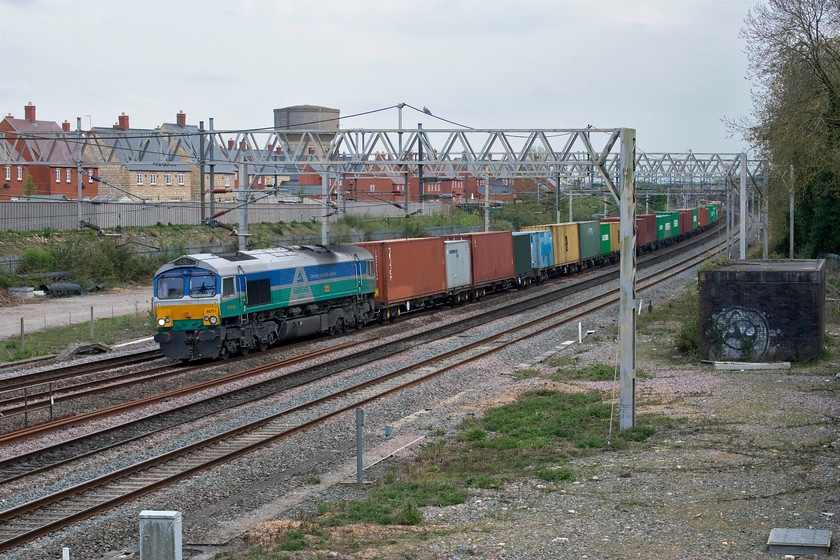 66711, 10.36 Felixstowe North-Hams Hall (4M23, 6E), site of Roade station 
 The 10.36 Felixstowe to Hams Hall (Birmingham) Freightliner passes through Roade with 66711 'Sence' leading. It makes a change to see a Class 66 in a different livery to the more usual WCML fayre. 66711 is owned and operated by GBRf and is the only member of the class to carry the Aggregate Industries blue, green and silver livery complete with green and blue Aggregate Industries logo. 
 Keywords: 66711 10.36 Felixstowe North-Hams Hall 4M23 site of Roade station GBRf 	
Sence