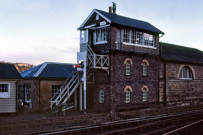 Whitby signal box (NER 1876) 
 The attractive and unusually tall Whitby signal box is seen in the dying afternoon light. The North Eastern Railway stone-built box was opened in 1876 closing a couple of years after this photograph was taken with the Esk Valley line becoming a long token block from Battersby meaning the abolition of all signalling infrastructure between the two. Whitby box was built unusually tall to give the signaller a clear line of sight over the top of the adjacent engine shed. 
 Keywords: Whitby signal box North Eastern Railway