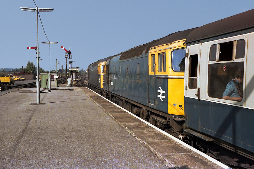 33021 & 33047, 09.20 Brighton-Exeter-St.-Davids (1V61), Salisbury station 
 33021 and 33027 double head the 1V61 09.20 Brighton to Exeter St. Davids train as it leaves Salisbury. It will travel up the L&SWR /GWR lines as far as Wilton Junction where it will diverge to the left and take the Wessex route to Exeter via Yeovil Junction. These Brighton workings were usually double headed by 33s but later on class 50s could also work them. Notice in this picture, Salisbury West signal box can be seen along with some of its associated signalling. Whilst I was on the platform end, I noticed an abandoned signal arm with a pile of rubbish over to the left of this image where the canary yellow BR vans are parked. I made some enquiries and ended up doing deal for 5 to buy it. The following week, my mum kindly went to salisbury after she had finished work in Warminster and picked it up for me. Some 40 years later I still have that signal arm and it is proudly displayed in my garden, see the image at the end of this section. 
 Keywords: 33021 33047 09.20 Brighton-Exeter-St.-Davids 1v61 Salisbury station