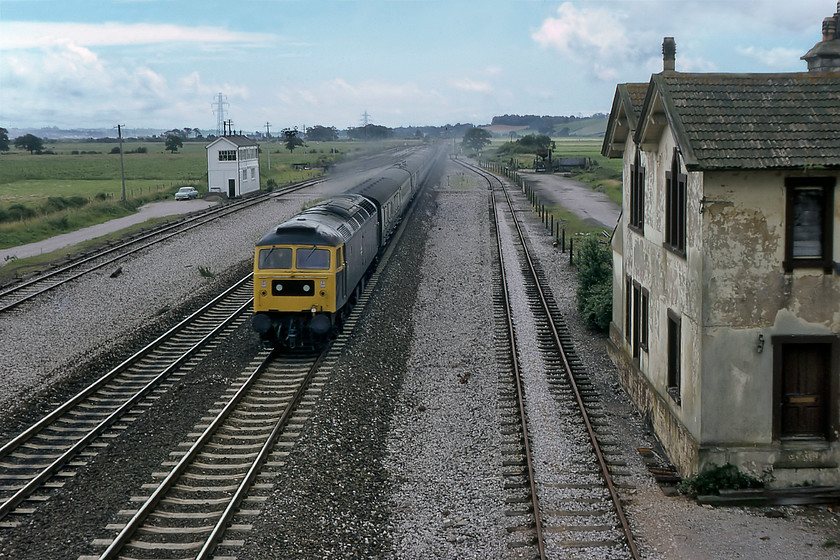 47477, 11.20 Paignton-London Paddington (1A71), Exminster 
 With the remains of Exminster station to the right (closed 30.06.64) 47477 rushes past with the 11.20 Paignton to Paddington service. According to contemporary records (The Rail Gen Archive), the Class 47 took over the 1A71 at Newton Abbot. Exminster signal box is seen to the left of the down loop. The station building survives today with the land beyond it occupied by various units including a large reclamation yard. 
 Keywords: 47477 11.20 Paignton-London Paddington 1A71 Exminster