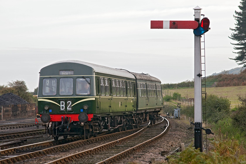 M51192 & M56352, 09.45 Sheringham-Holt, Weybourne station 
 The first service of the day on the North Norfolk Railway enters Weybourne station worked by preserved class 101 DMU M51192 and M56352. This could be a period scene from anywhere in Norfolk from M&GN days with the summersault signal and store of coal in the background and evokes an atmosphere if times gone by. 
 Keywords: M51192 M56352 09.45 Sheringham-Holt Weybourne station