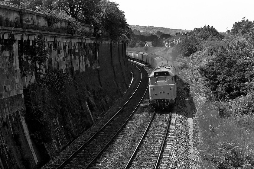 31286, up parcels, Hampton Row footbridge ST761658 
 Taken a little into the sun from Hampton Row footbridge to eastern end of Bath 31286 is seen accelerating away from the city with an up parcels working. The huge stone and brick retaining wall to the left has the Kennet and Avon Canal running along the top of it. 31286 was a local locomotive being based at Bristol Bath Road surviving in service until December 1991. 
 Keywords: 31286 up parcels Hampton Row footbridge ST761658