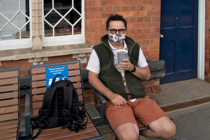 4. Yours truly, Wellingborough station 
 Yours truly sitting on Wellingborough station working out how to partake in my coffee whilst wearing my requisite face-covering! On our journey to Wakefield, we observed almost complete compliance with the compulsory face mask policy whilst using public transport. 
 Keywords: Yours truly Wellingborough station