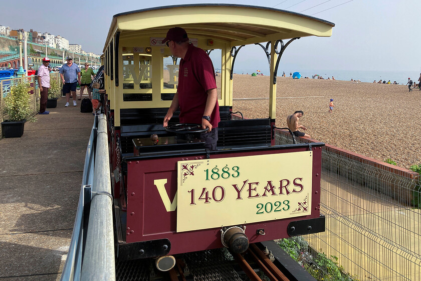 Cars 10 & 6 , Black Rock-Aquarium working, Aquarium station 
 After taking lunch in a very nice air-conditioned restaurant at Brighton Marina my wife and I travelled back from Black Rock station to Aquarium on the Volk's Electric Railway (VER). After arrival at Aquarium station near to Brighton Pier, I turned my camera back to capture Cars 10 and 6 being prepared for the next return trip. Of the three cars that we travelled on, Car 6 was the oldest dating from 1901 and was fairly fresh from a lottery-funded overhaul in 2018. Incidentally, whilst the line has been in existence for one hundred and forty years it was shut completely between 1940 and 1948 and is only a seasonal operation. 
 Keywords: Cars 9 & 6 Black Rock-Aquarium working Aquarium station