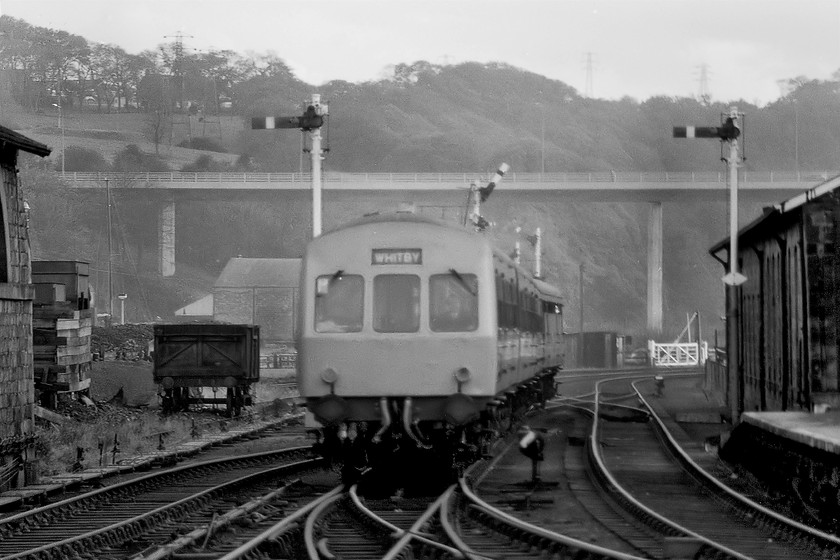 Class 101 hybrid DMU, unidentified Middlesbrough-Whitby working, Whitby station 
 An unidentified DMU working arrives at Whitby station with a working from Middlesbrough. Whilst this DMU is led by a smart-looking Class 101 the rear power car was a Class 104. Looking beyond the somewhat antiquated railway infrastructure the newly opened A171 high-level bridge is seen. This was designed and built to ease congestion in Whitby's centre where the road crossed the town's tiny swing bridge. 
 Keywords: Class 101 hybrid DMU unidentified Middlesbrough-Whitby working Whitby station