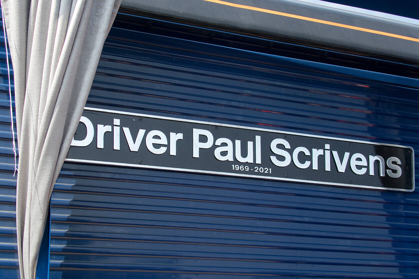 Nameplate, 66424, on display, Crewe Gresty Bridge 
 The second naming of the day at DRS' Gresty Bridge open day was 66424 'Driver Paul Scrivens 1969-2021'. After a short but emotionally driven couple of eulogies by DRS' Tim Howlett and Pauls sister, Emma the plate was unveiled to a resounding round of applause from those gathered around. Paul was a career railwayman whose love of the industry ran deep in his blood but who tragically died at the untimely age of fifty-two in 2021. 
 Keywords: Nameplate 66424 on display Crewe Gresty Bridge Driver Paul Scrivens 1969-2021