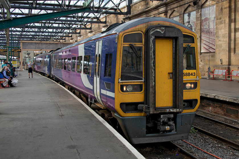 158843, NT 16.23 Carlisle-Chathill (2A40, 1L), Carlisle station 
 158843 waits to leave Carlisle with the 16.23 to Chathill. This is an unusual working and is one of Chathill's four daily trains. The station is located on a remote spot of the ECML between Alnmouth and Berwick-upon-Tweed. On arrival at the quiet rural station, that is a long way from anywhere of substantial population, it runs as ECS northwards for a distance of about three miles to Belford crossovers where it returns south again to Newcastle after making another stop at Chathill. This performance occurs twice daily giving Chathill its four trains. All the stations visited in 2017, see their video at.... https://www.youtube.com/watch?v=AHrIufNLs4U and go to about nine minutes in. It's unfortunate that Geoff states several times that it only has two trains per day, carefully studying of the timetable would reveal the early morning pair making the total of four! 
 Keywords: 158843 16.23 Carlisle-Chathill 2A40 Carlisle station