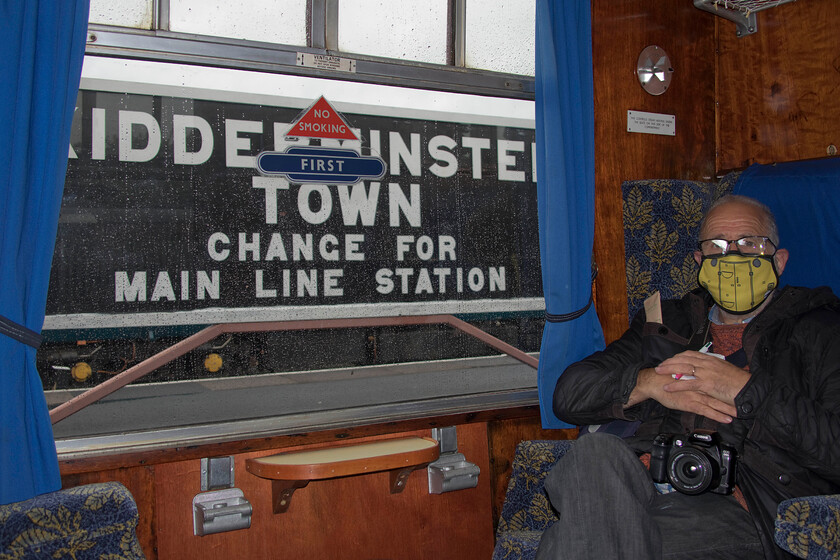 Andy on-board 10.10 Kidderminster-Bridgnorth, Kidderminster SVR station 
 Andy luxuriates himself in the sumptuous seating of a Mk1. compartment waiting to leave Kidderminster as the first journey of our trip to the SVR's diesel gala. We both commented on the stark contrast with today's appalling seating offered by train manufacturers. The hard and cramped seating (including those in first-class as is shown here) is such a retrograde step with the luxurious interiors as seen here much lamented. 
 Keywords: Andy on-board 10.10 Kidderminster-Bridgnorth, Kidderminster SVR station