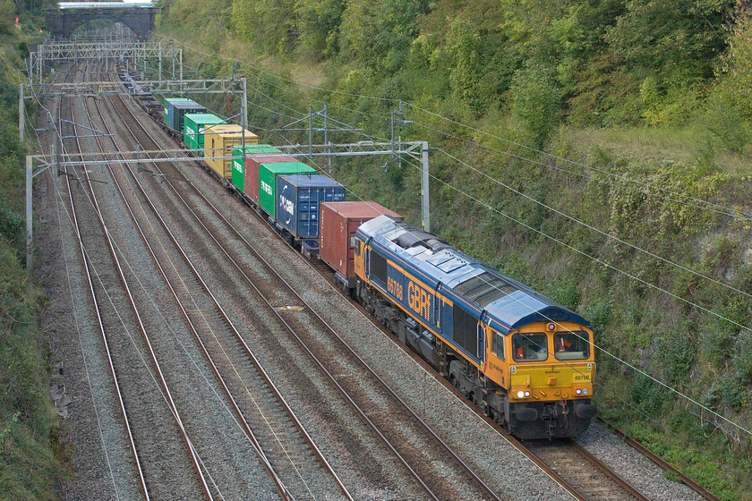 66768, 12.03 Birch Coppice-Felixstowe North (4L05, 81L), Hyde Road bridge 
 The long but rather lightly loaded 4L05 12.03 Birch Coppice to Felixstowe Saturday afternoon service comes through Roade cutting at a fair pace with GBRf's 66768 leading. With the fast lines via Weedon closed all weekend for engineering works some workers are seen undertaking work on the cutting wall to the top left. They appeared to be drilling into the missionary and attaching harness points. 
 Keywords: 66768 12.03 Birch Coppice-Felixstowe North 4L05 Hyde Road bridge GBRf